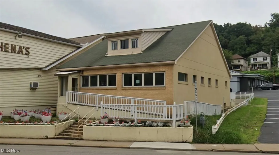 View of front of home with stairway and brick siding