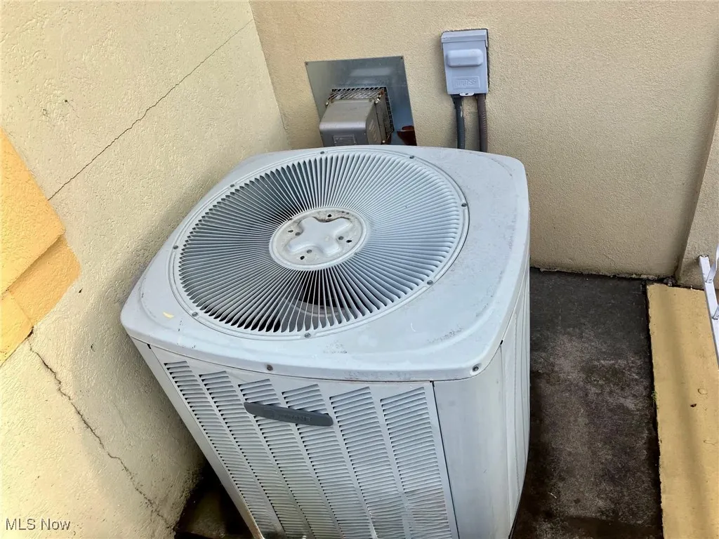 Exterior details featuring central air condition unit and stucco siding
