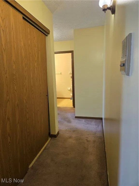 Hallway with utilities on left