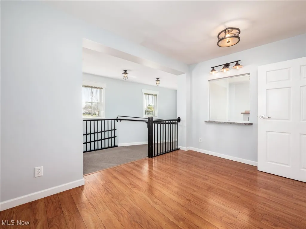 Spare room with wood finished floors and baseboards