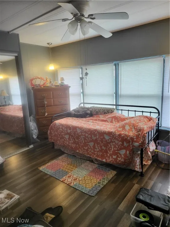 Bedroom with dark wood-type flooring and a ceiling fan