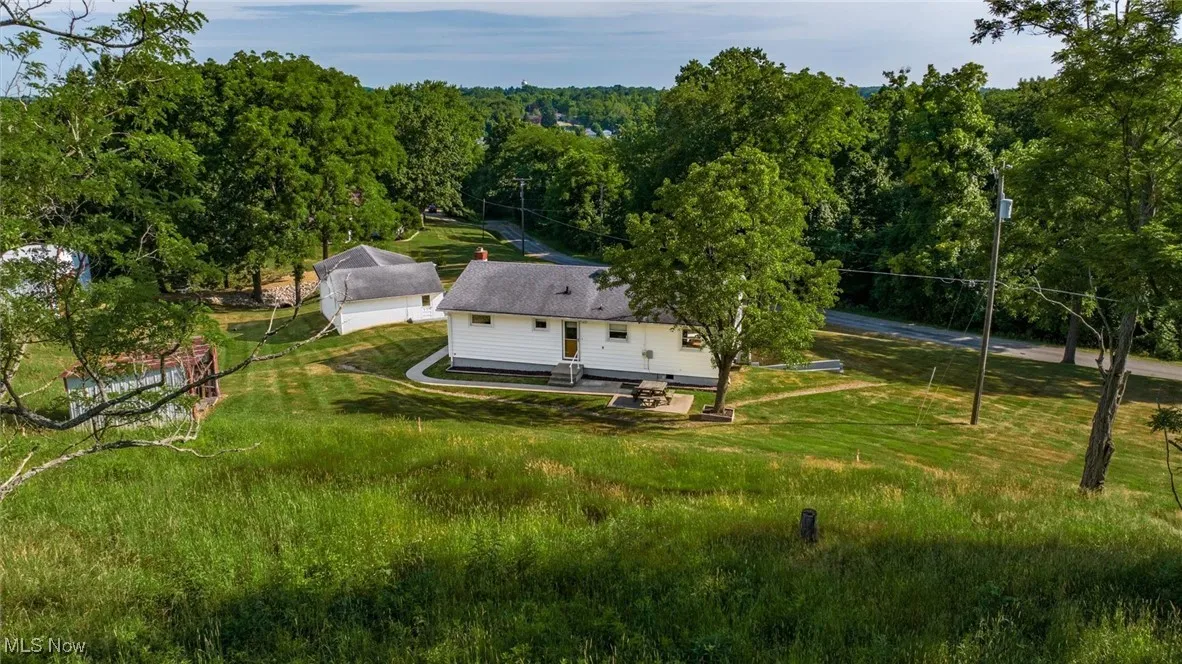 Aerial view featuring a forest view