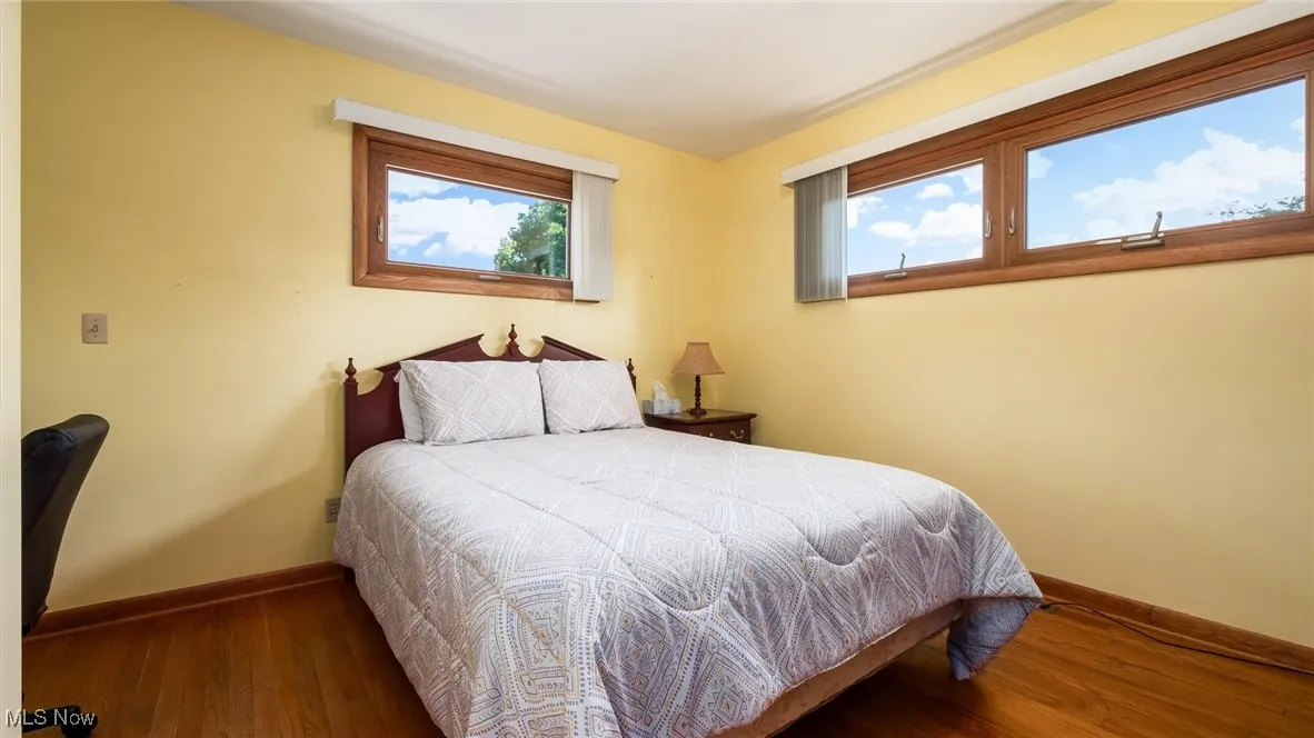 Bedroom featuring baseboards and wood finished floors