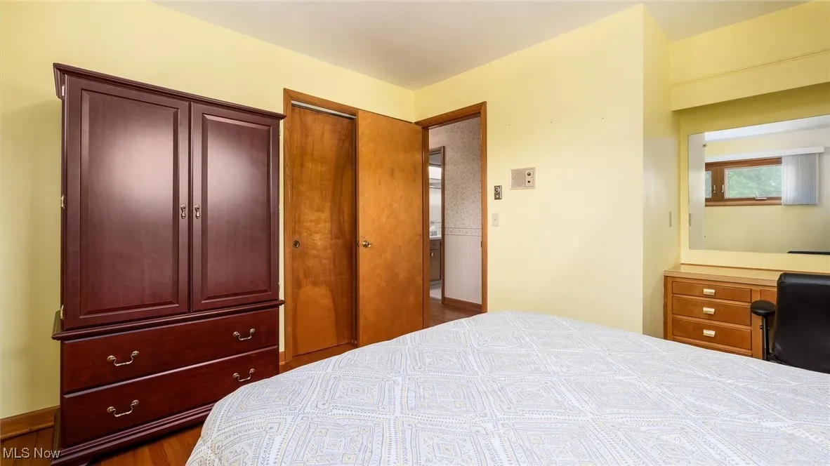 Bedroom with a closet and wood finished floors
