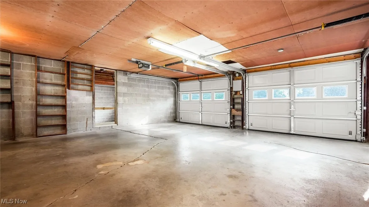 Garage with a garage door opener and concrete block wall