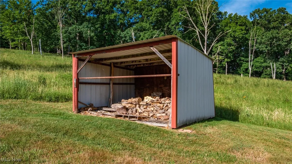 View of pole building featuring a yard and a detached carport