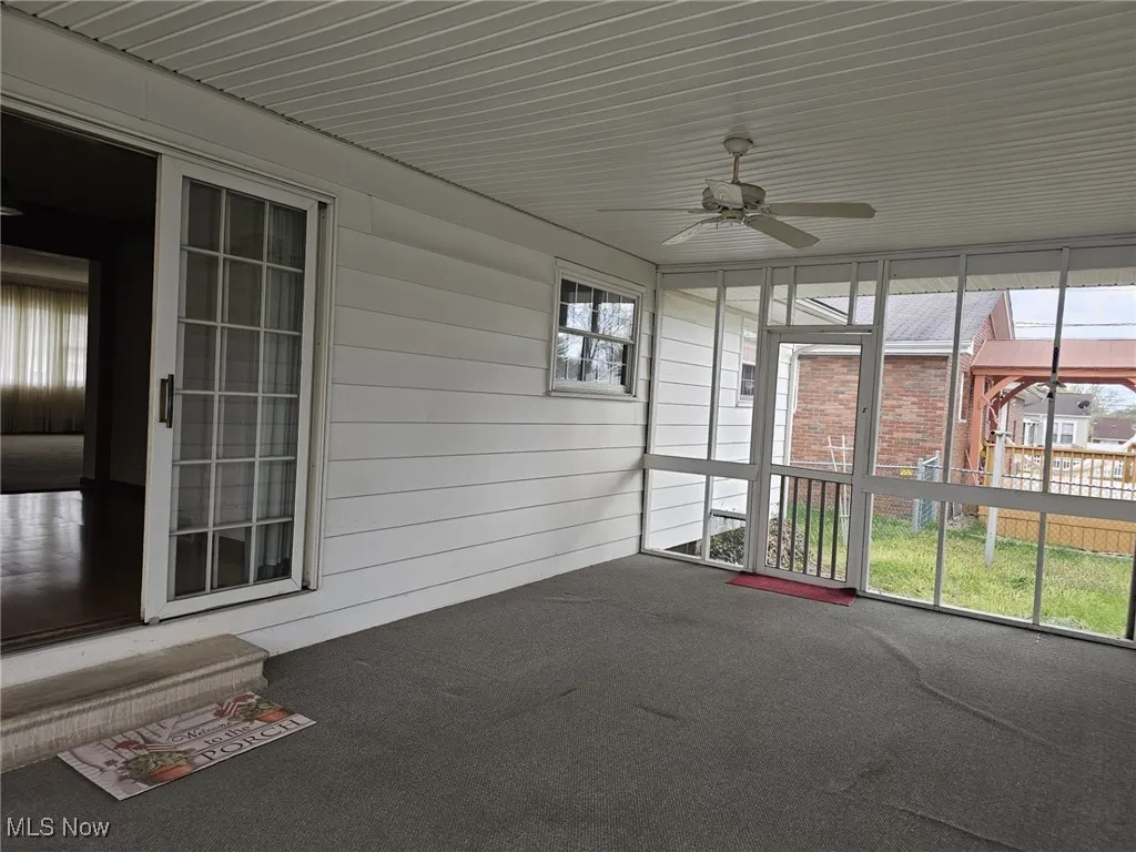 Large Living Room.  Hardwoods under carpet.  Showing entry to kitchen