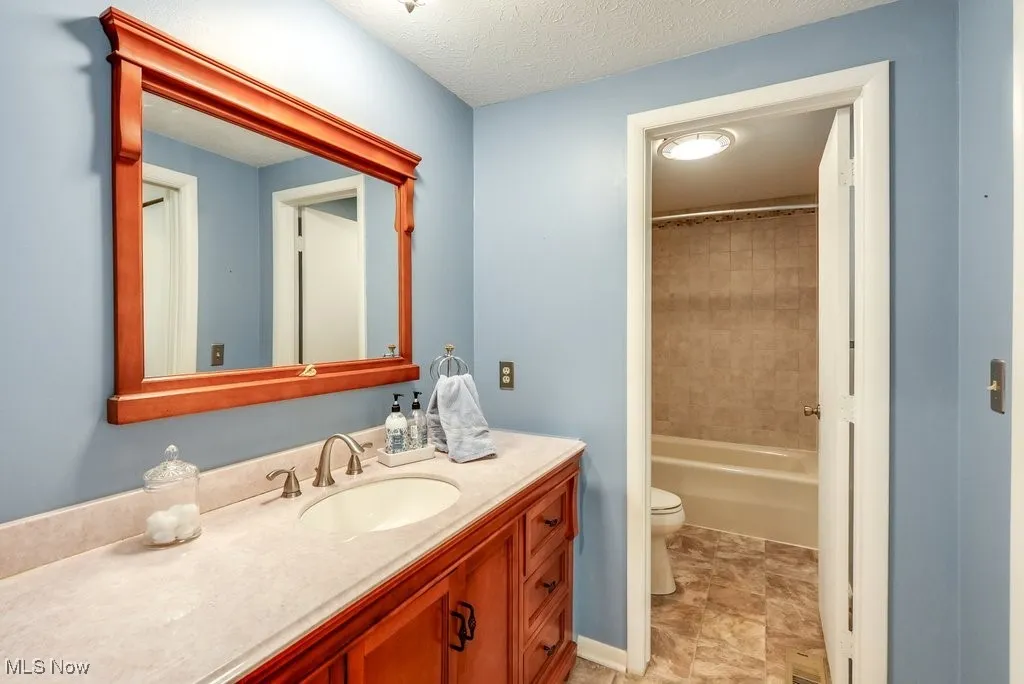 Full bath featuring vanity and toilet