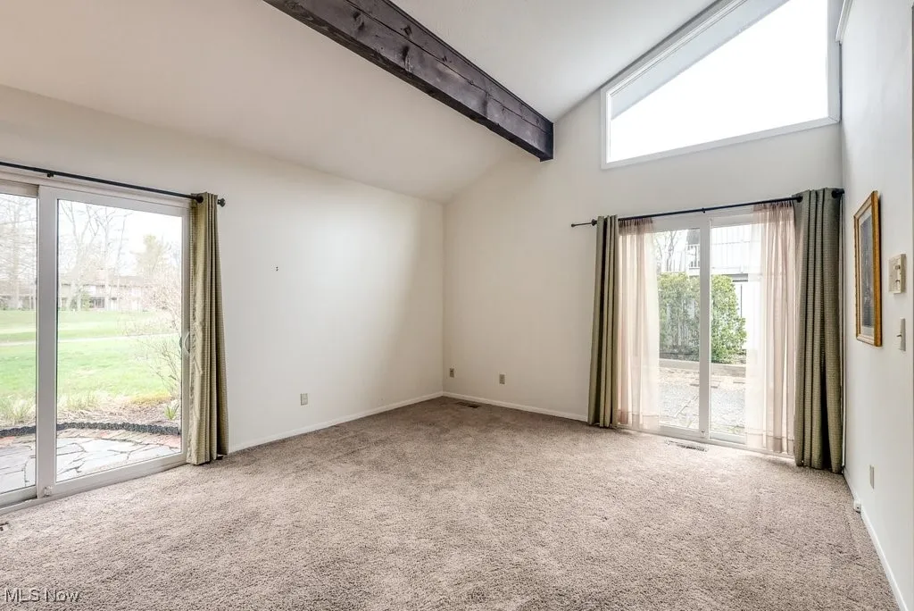  featuring high vaulted ceiling,  baseboards, and beam ceiling