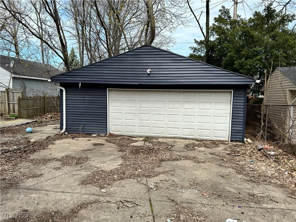 Detached garage featuring fence