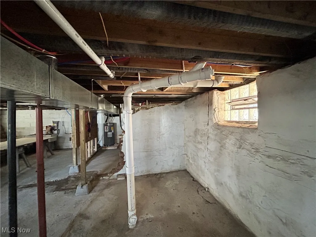 Unfinished below grade area with electric water heater