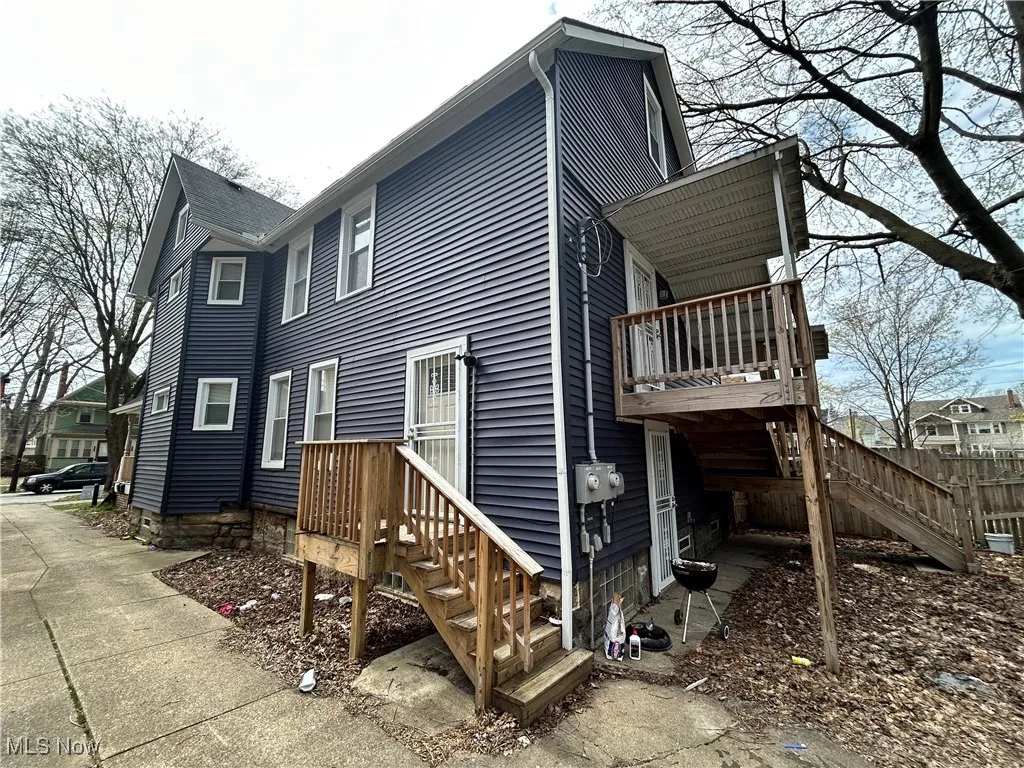 View of property exterior with stairway