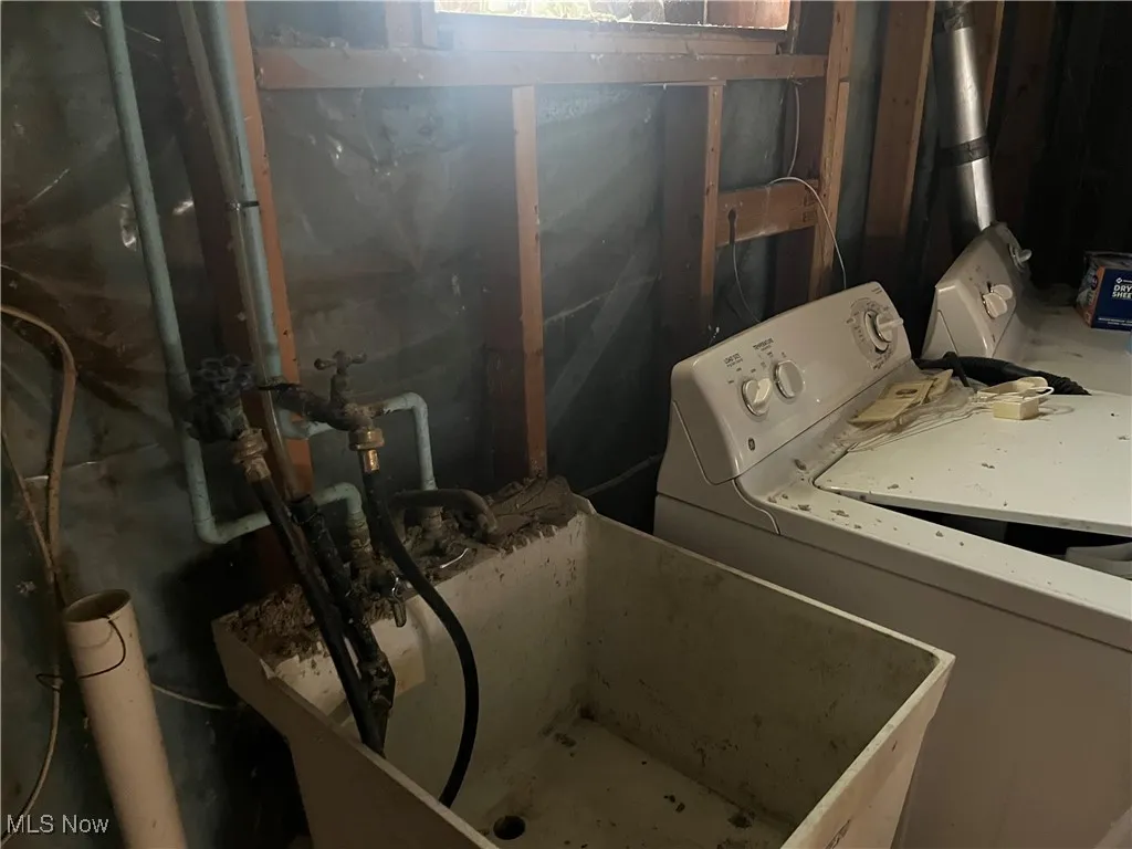 Laundry area featuring washer / dryer, laundry area, and a sink