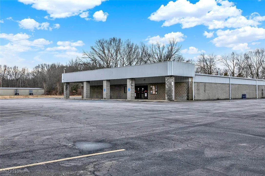 View of property with uncovered parking