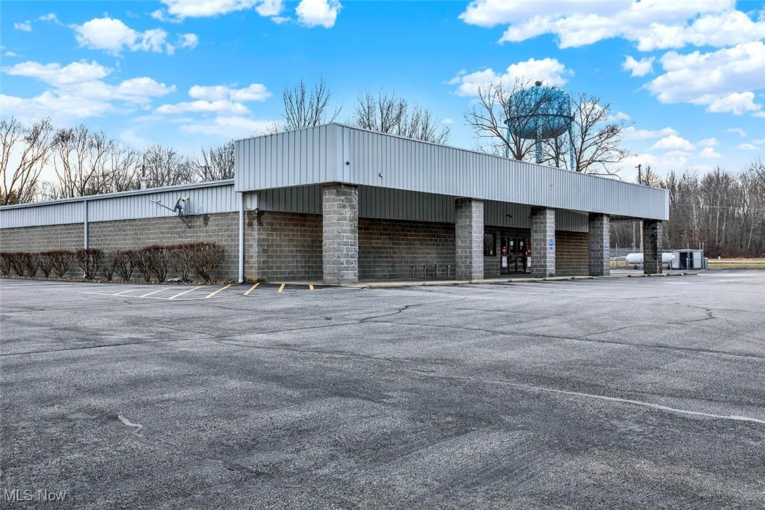 View of property with uncovered parking