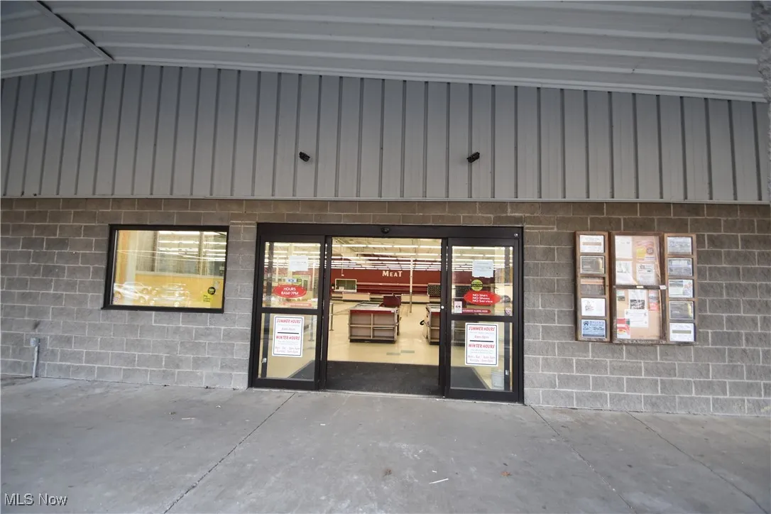 Doorway to property with concrete block siding