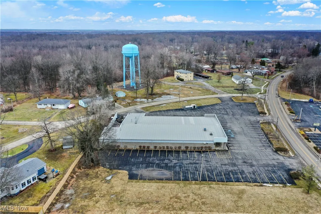 Birds eye view of property with a wooded view