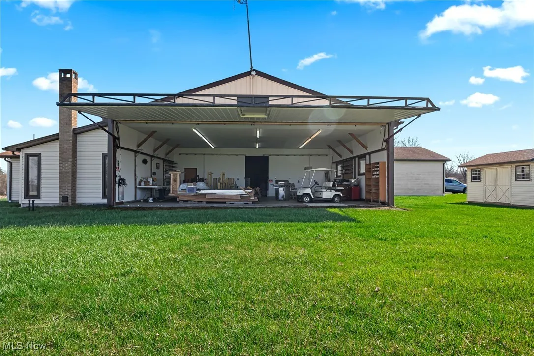Side of property with a full length door that opens and serves as an airplane hangar