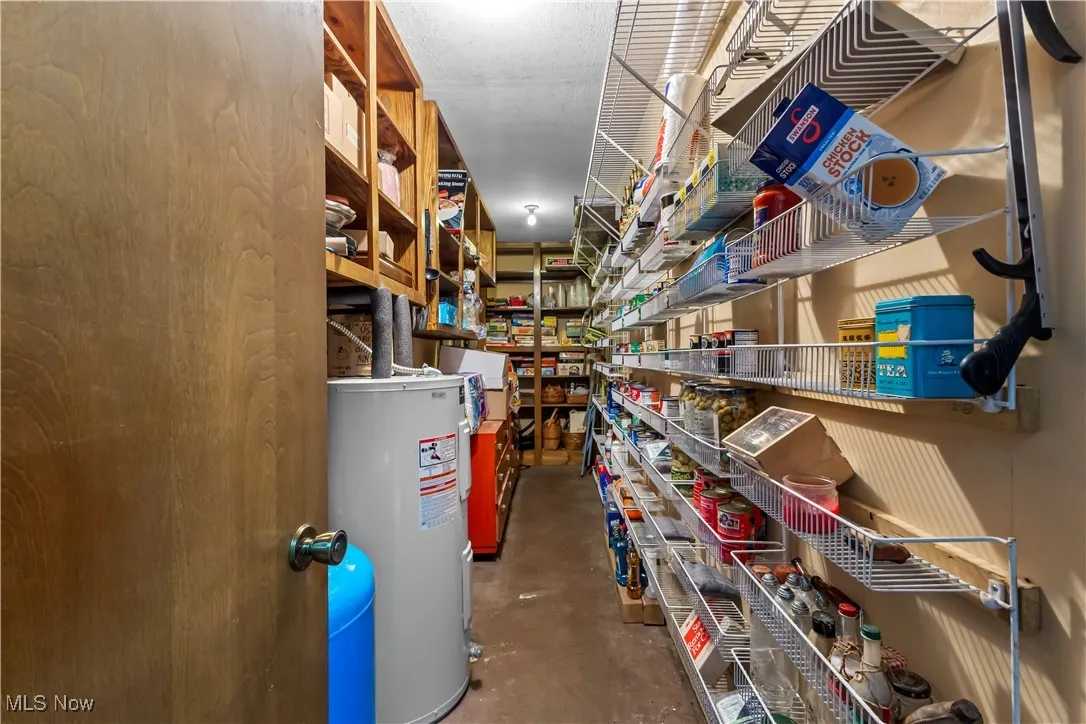 Storage area featuring electric water heater