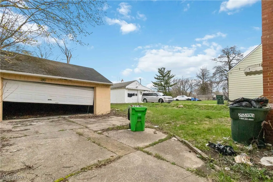 View of yard featuring a garage and an outdoor structure