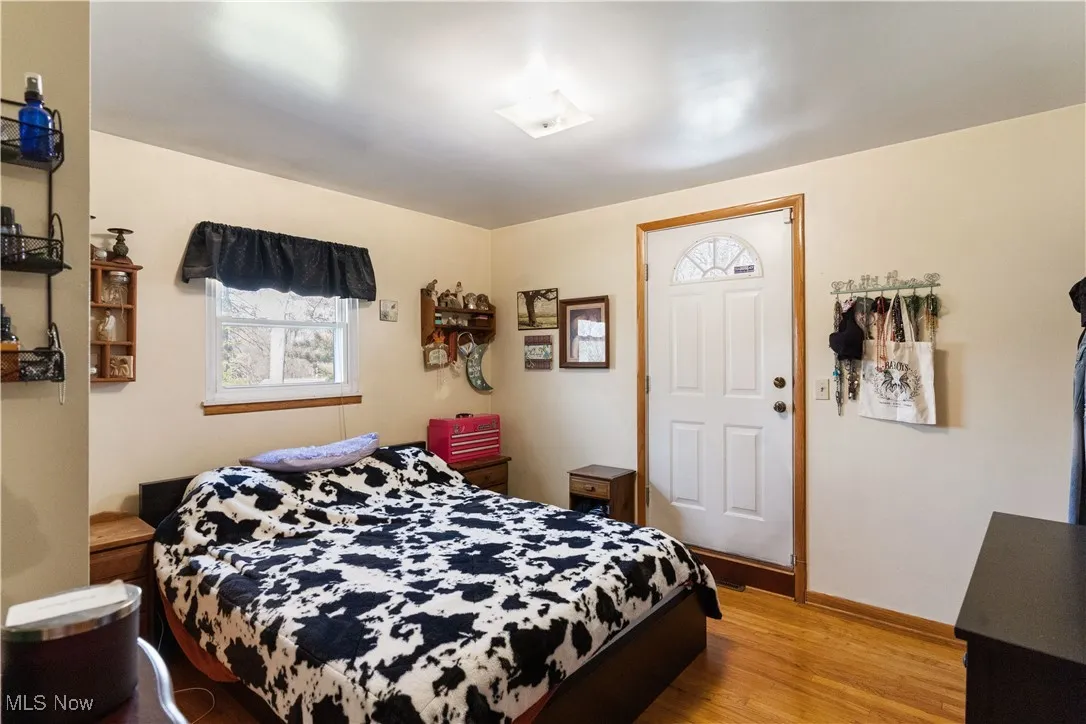 Bedroom featuring baseboards and wood finished floors