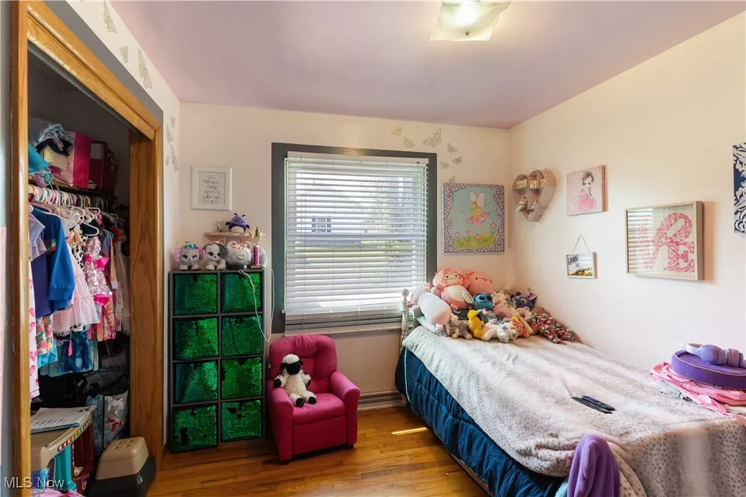 Bedroom featuring wood finished floors and a closet