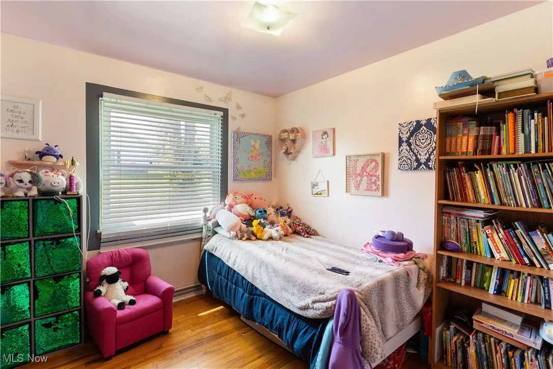 Bedroom featuring wood-type flooring and baseboards