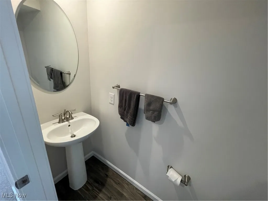 Bathroom featuring baseboards and wood finished floors