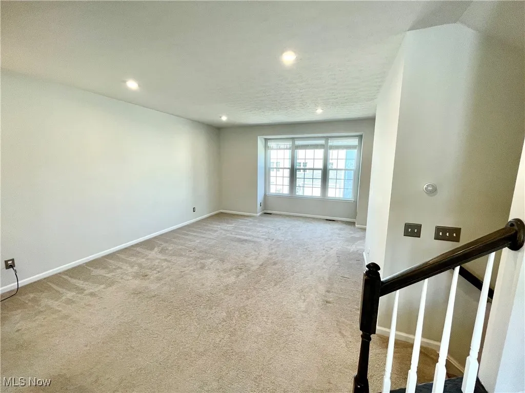 Unfurnished room featuring recessed lighting, baseboards, and light colored carpet