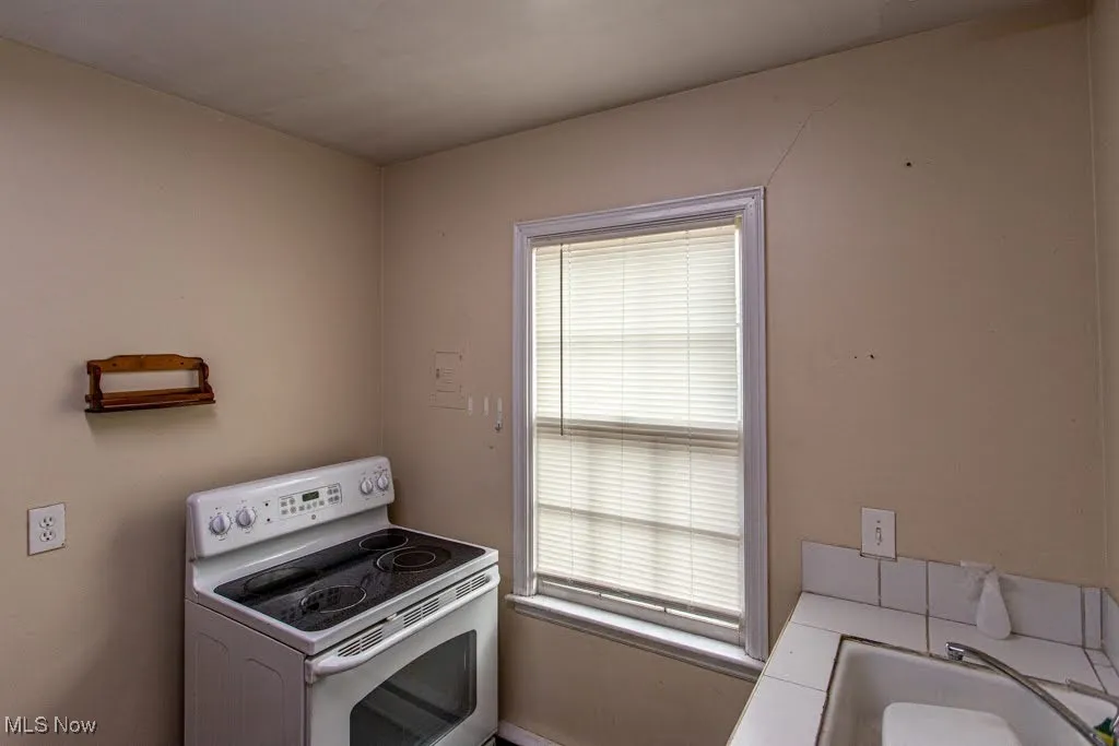 Kitchen with a sink and white electric range
