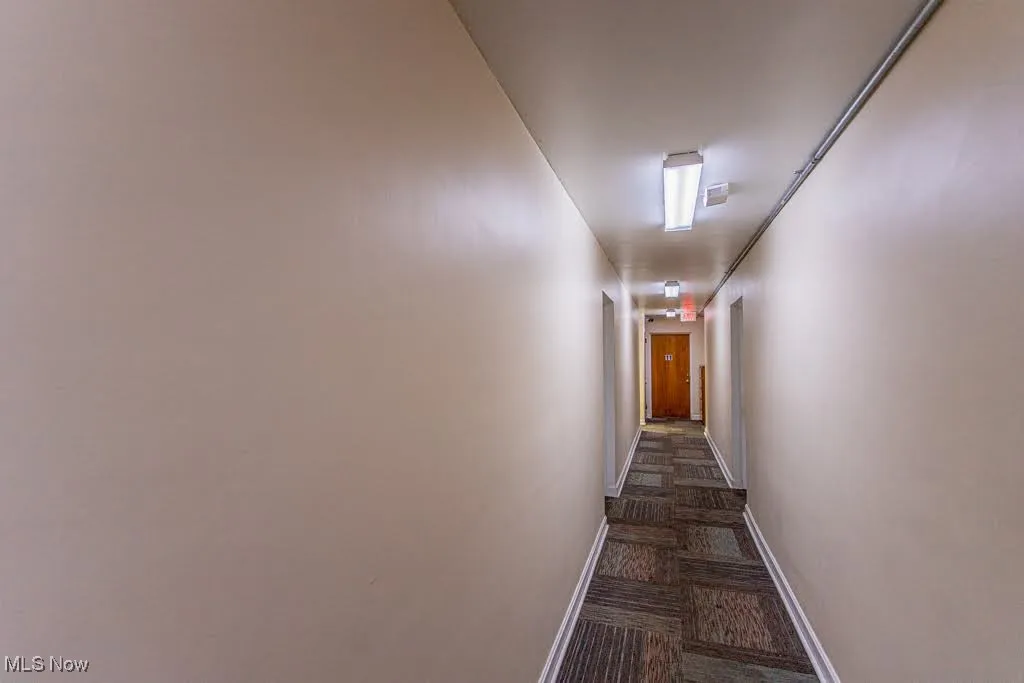Corridor featuring baseboards
