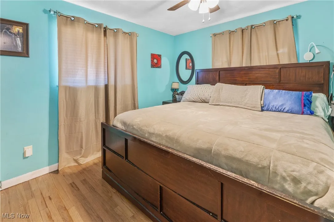 Bedroom with baseboards, a ceiling fan, and wood finished floors