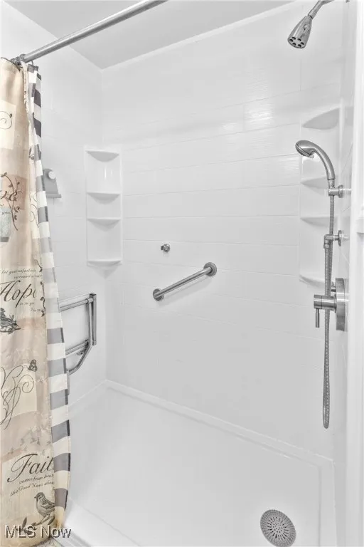 Full bathroom with a shower stall
