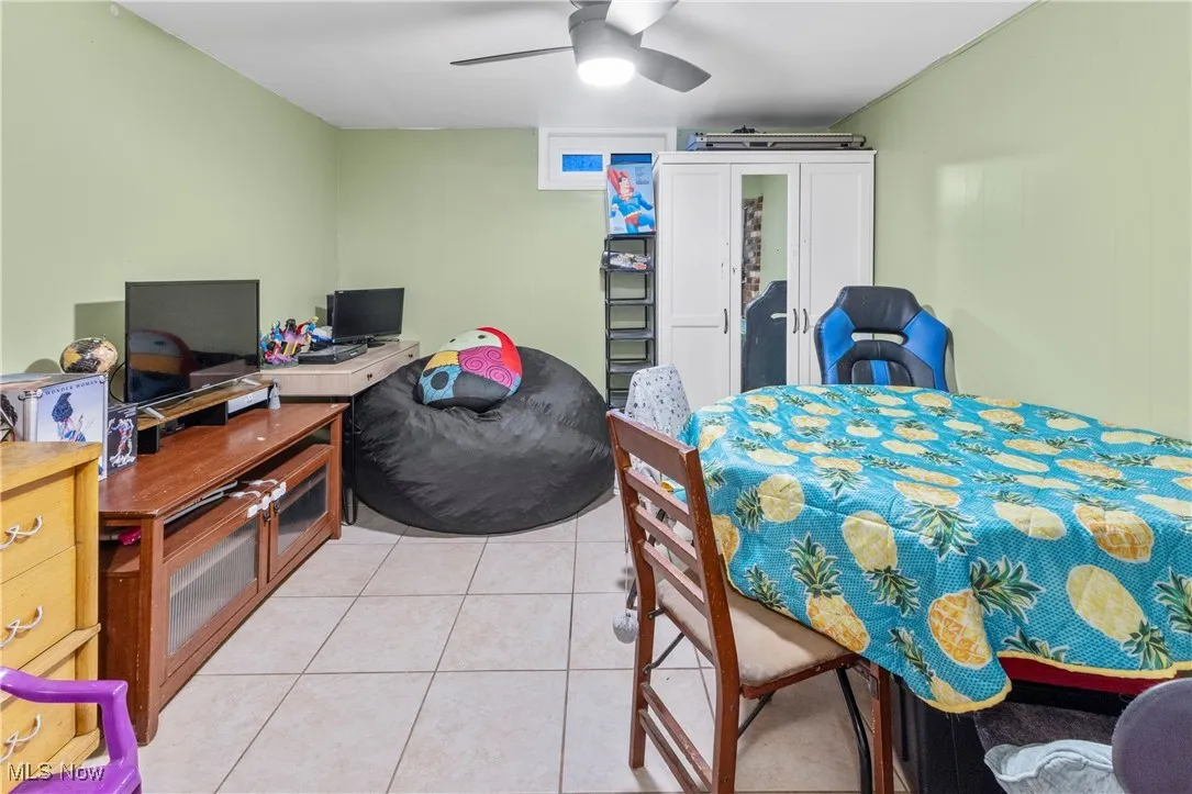 Bedroom featuring a ceiling fan and light tile patterned flooring