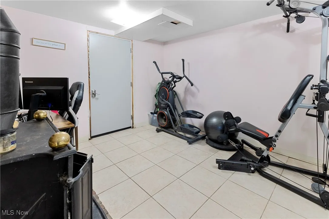 Exercise area with visible vents and light tile patterned floors