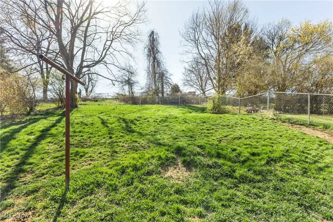 View of yard featuring fence