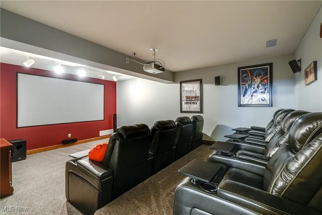 Dedicated home theater in lower level with projector and screen and speakers throughout.