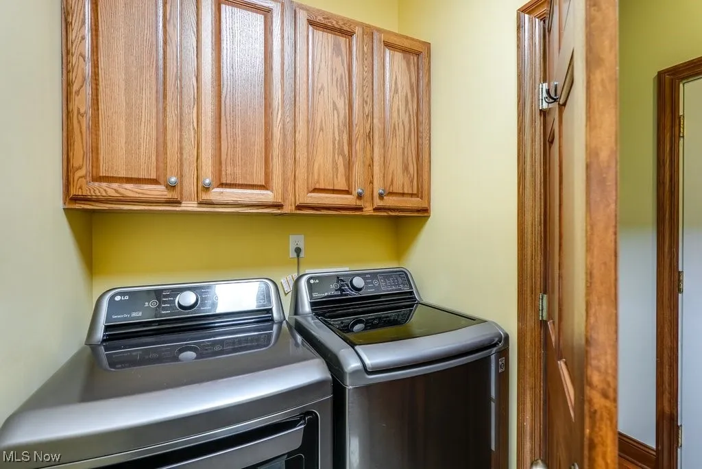 First floor laundry with cabinets and laundry sink