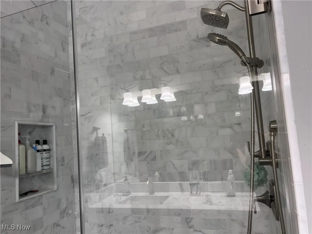 Spacious Marble shower with bench