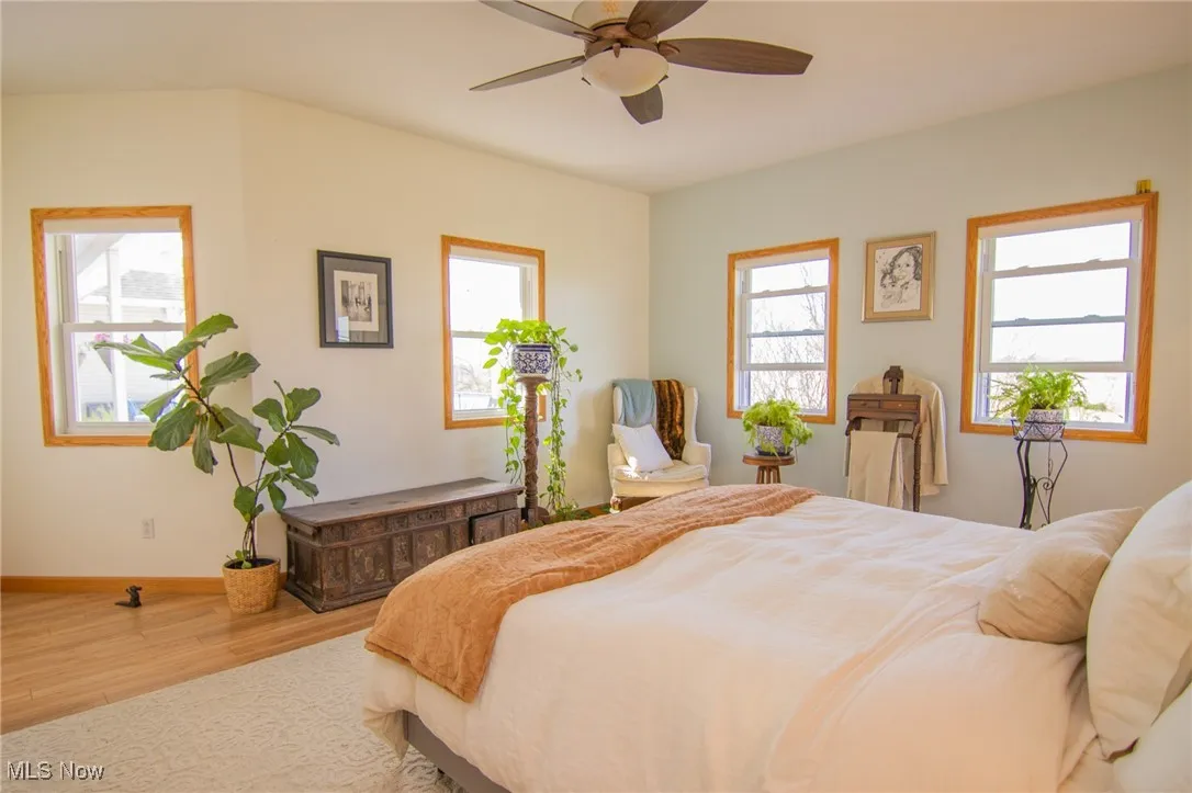 Bedroom with baseboards, a ceiling fan, and wood finished floors