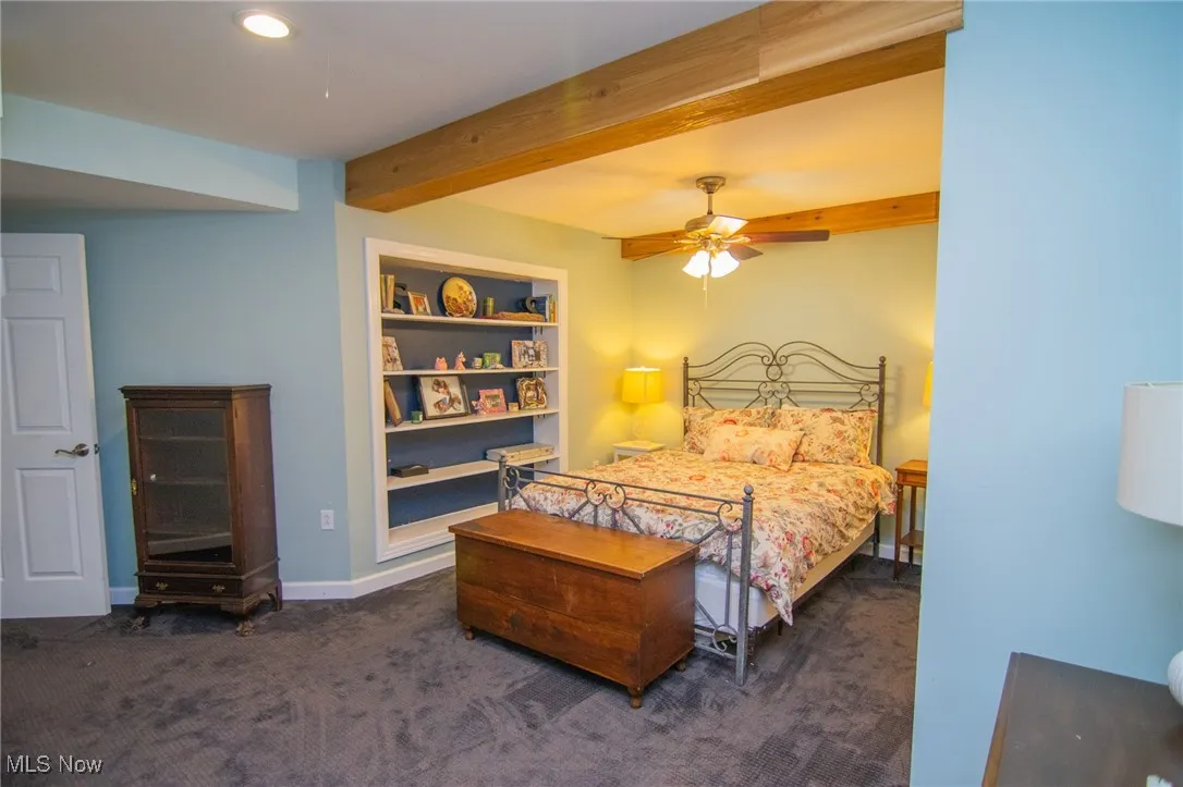 Carpeted bedroom featuring beamed ceiling, baseboards, ceiling fan, and recessed lighting