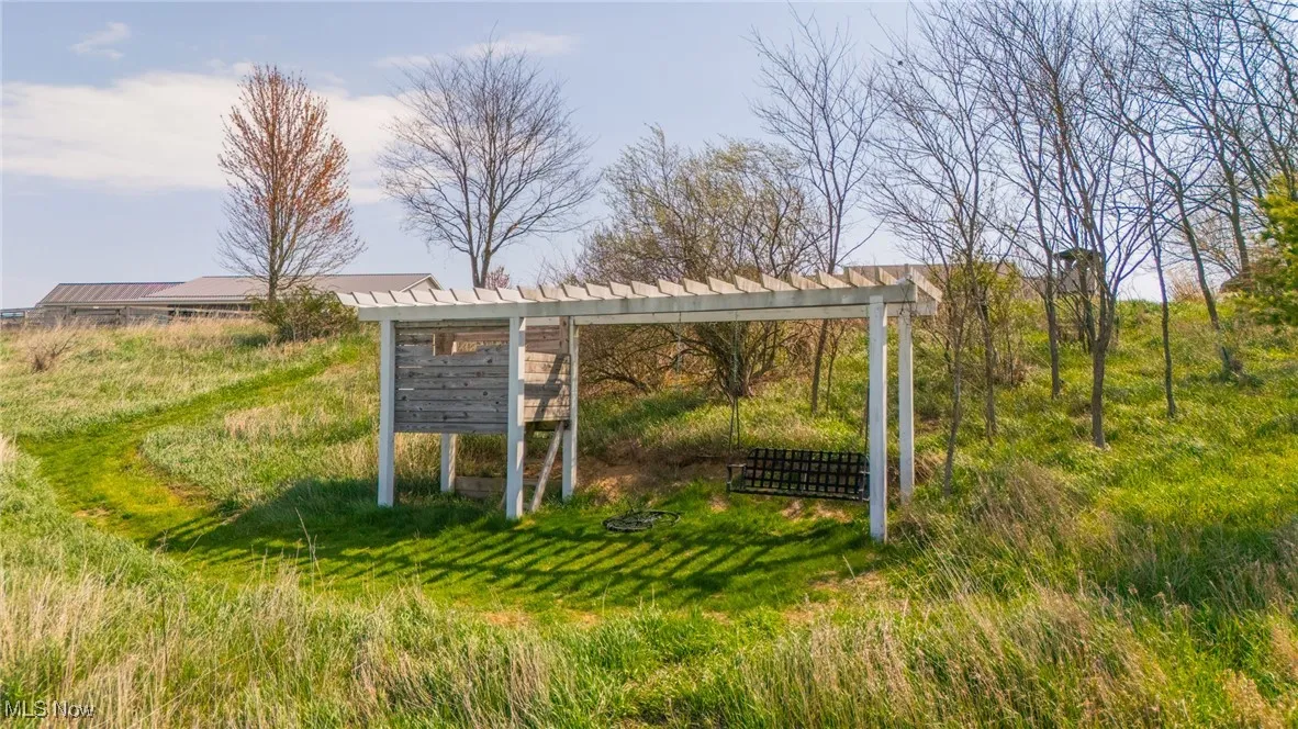 View of property's community featuring a pergola and mail area
