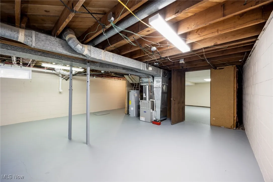 Below grade area with heating unit and water heater