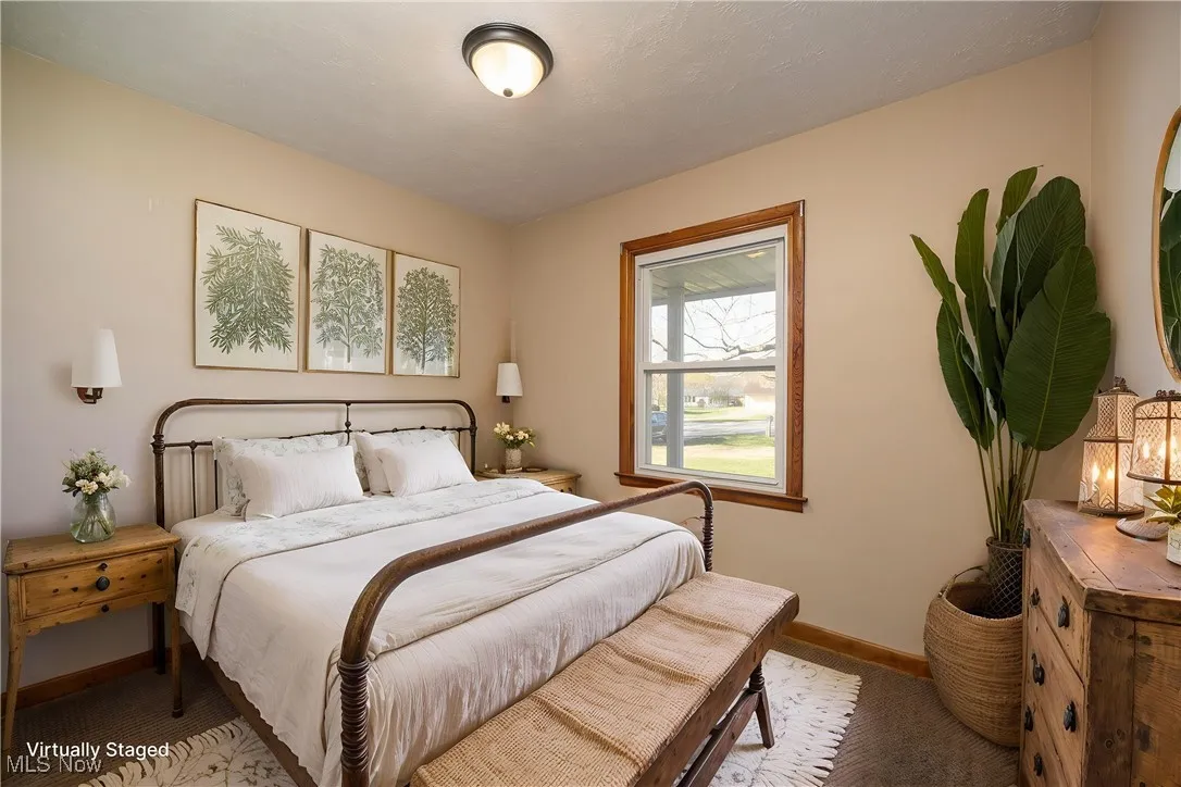 Virtually staged bedroom with baseboards and carpet flooring