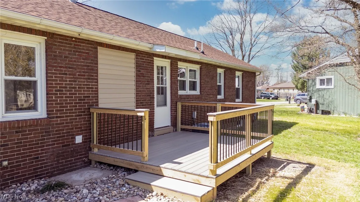 Wooden deck featuring a lawn