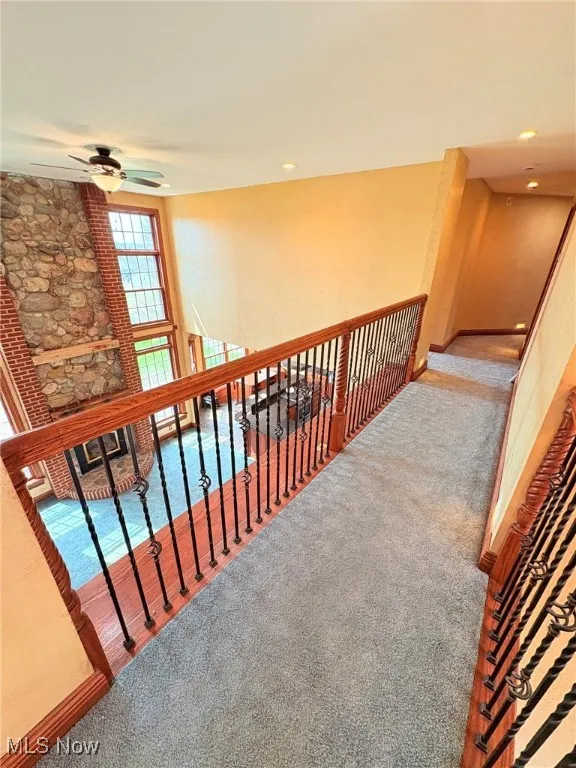 Second floor banister looking over into the great room with vaulted ceilings.