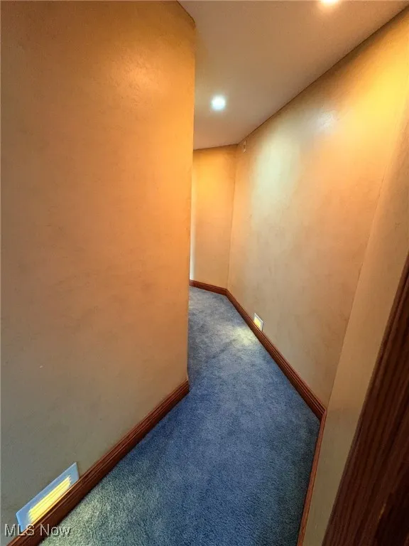 upstairs hallway with floorboard lighting.