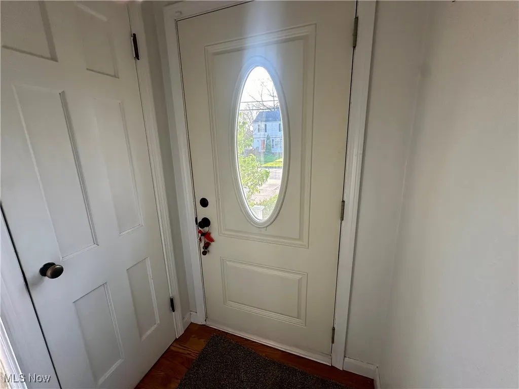 Doorway featuring dark wood-type flooring