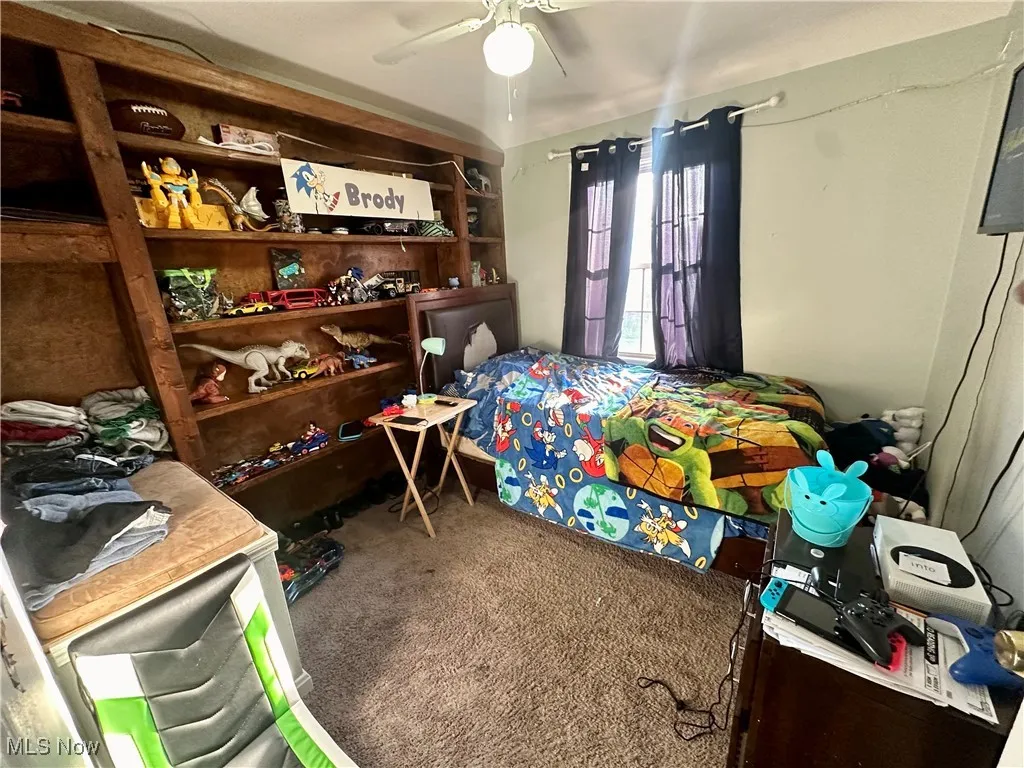 Bedroom featuring ceiling fan and carpet floors