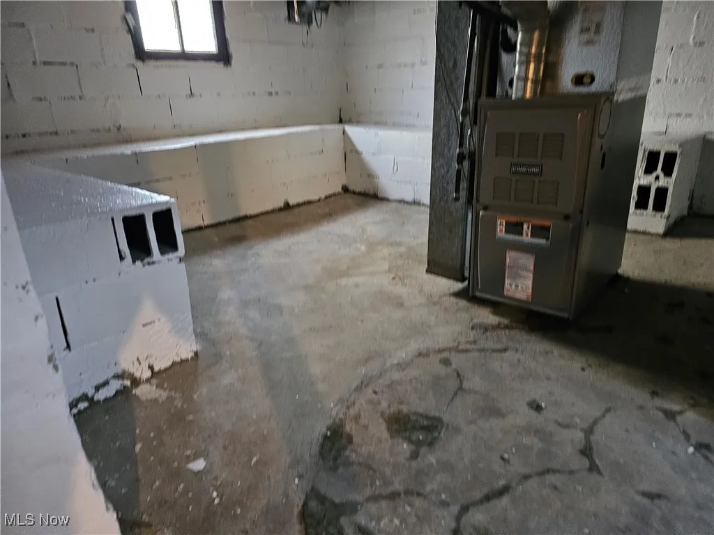 Below grade area featuring concrete block wall